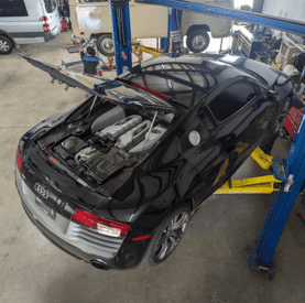 High-quality black Audi vehicle being serviced on a hydraulic lift at Destination Autoworks.