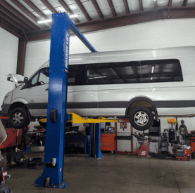 Vehicle lift at Destination Autoworks for auto repair and maintenance.