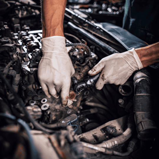 Engine repair, mechanic working on car engine, auto repair service.