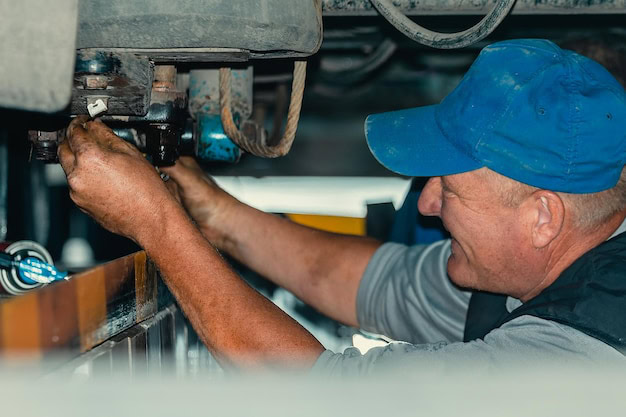 Exhaust system repair technician working on vehicle in Shippensburg.