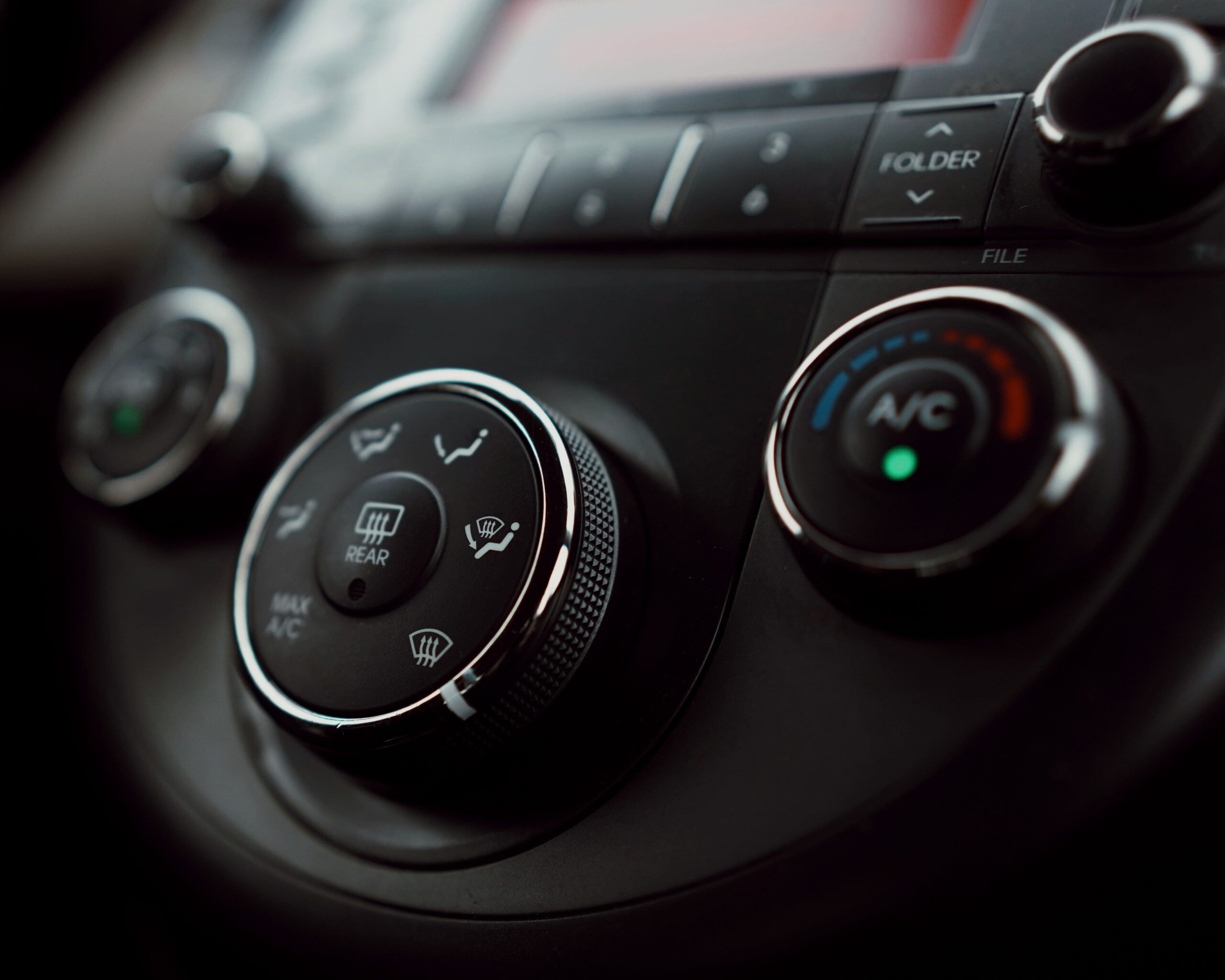 Auto climate control system with temperature and fan settings in a vehicle dashboard.