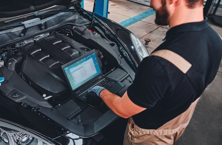 Engine diagnostics being performed by a technician at Dettwiler Brothers Repair.