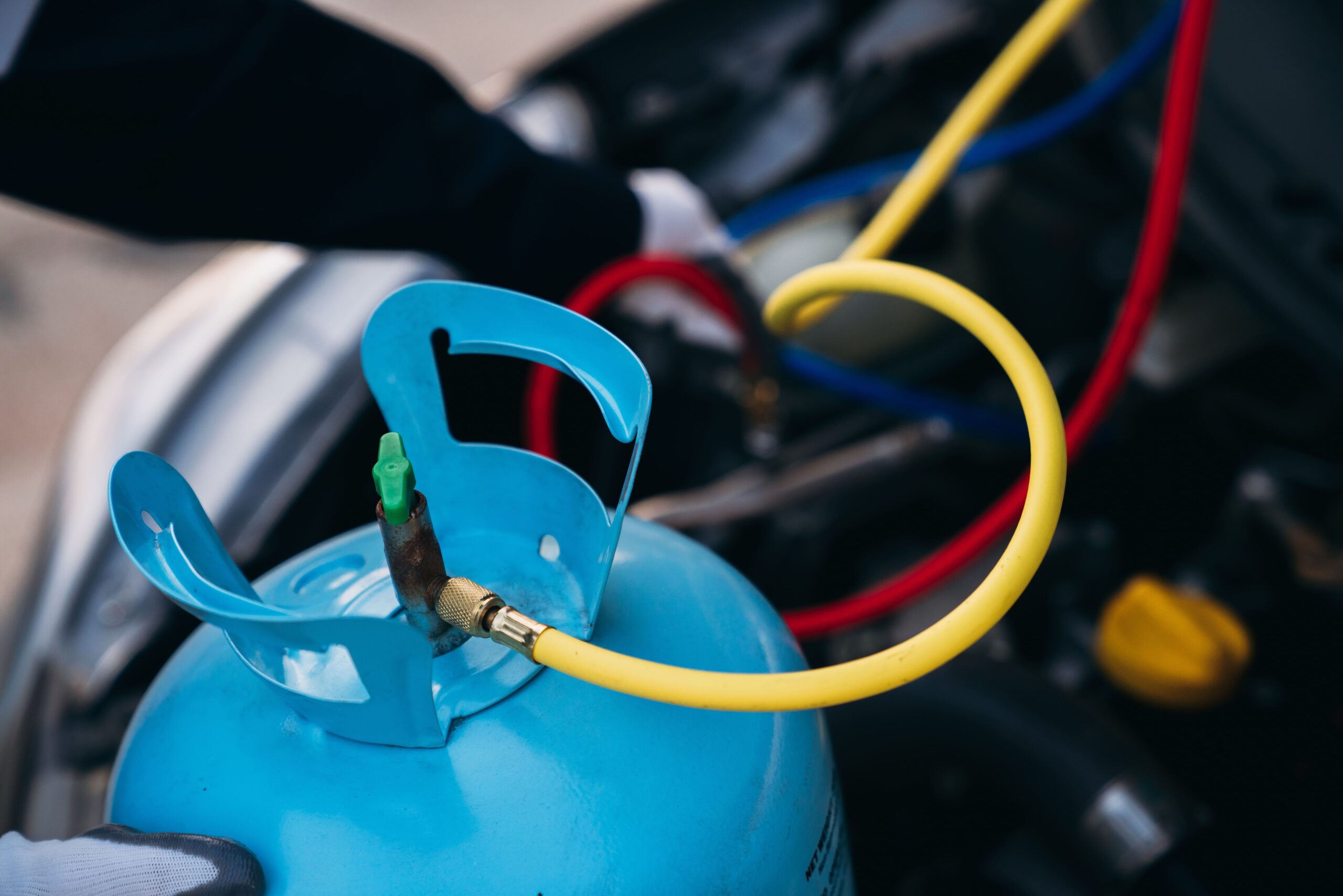 Refrigerant recharge in progress at Dettwiler Brothers Repair, ensuring optimal car AC performance.