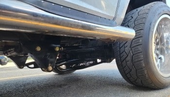 Close-up of a vehicle's undercarriage with performance modifications.