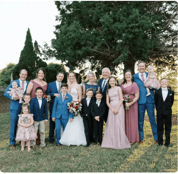 Family and friends gathered for a wedding photo outdoors at DrivenMotos Auto Care Clinic.