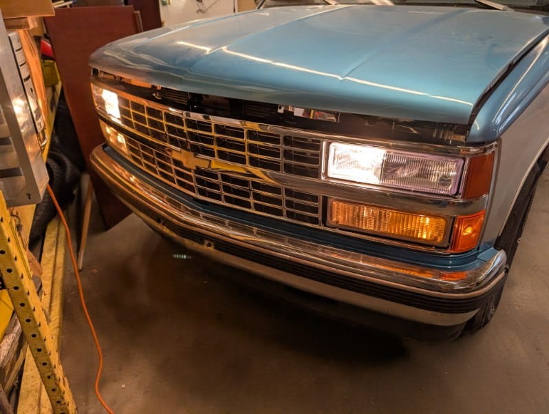 Classic Chevrolet front view in auto repair shop.