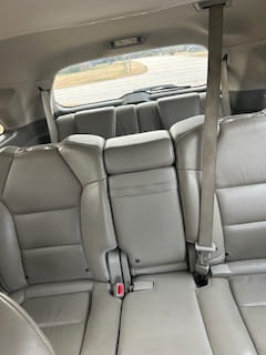 Auto care clinic interior with clean, comfortable car seats and seat belts.
