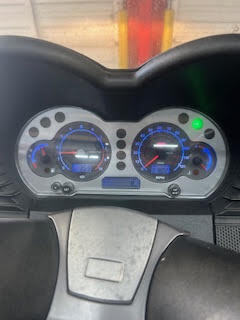 Close-up of car dashboard with speedometer and fuel gauge at DrivenMotos.