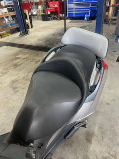 Motorcycle seat at DrivenMotos Auto Care Clinic for maintenance and repair.