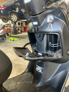 Close-up of scooter dashboard at DrivenMotos Auto Care Clinic.