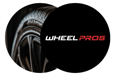 Close-up of high-performance car wheels with Wheel Pros logo.
