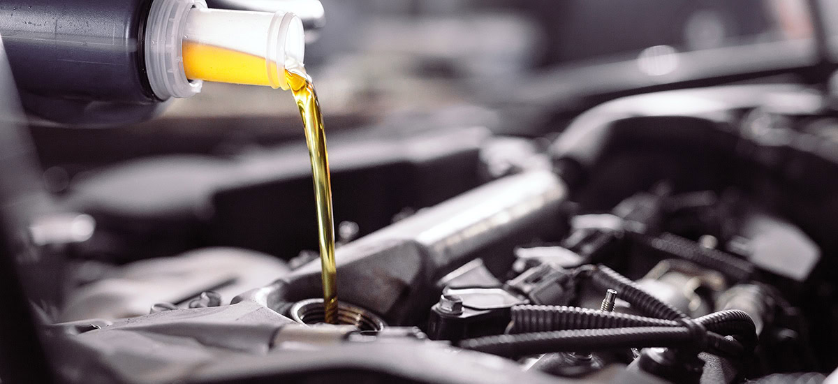 pouring fresh oil into car engine