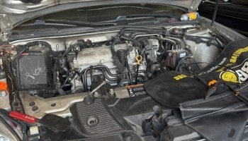 Close-up of a car engine showing detailed components and mechanical parts.