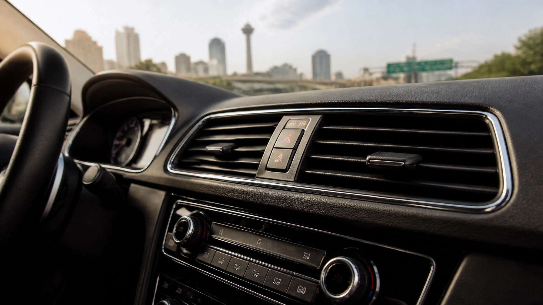 Dashboard of a modern vehicle with city skyline visible through the windshield.