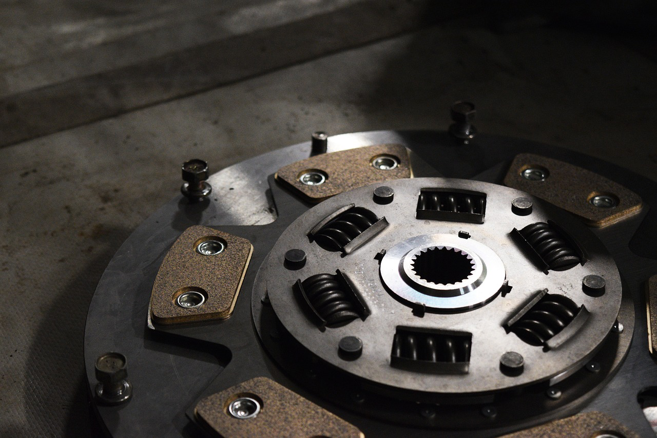 Clutch assembly with friction plates and pressure plate for clutch repair.