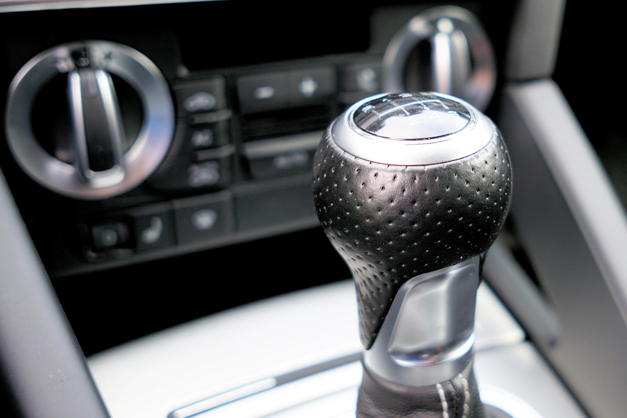 Close-up of car gear shift lever in vehicle interior.