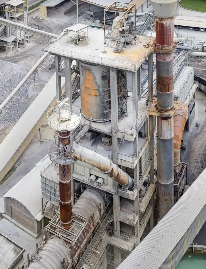 Industrial factory with large chimneys and processing equipment.