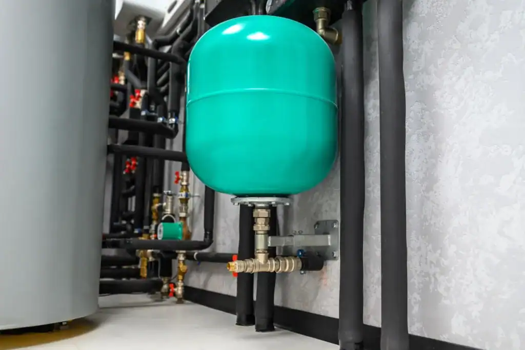 Industrial boiler expansion tank with connected piping and valves.