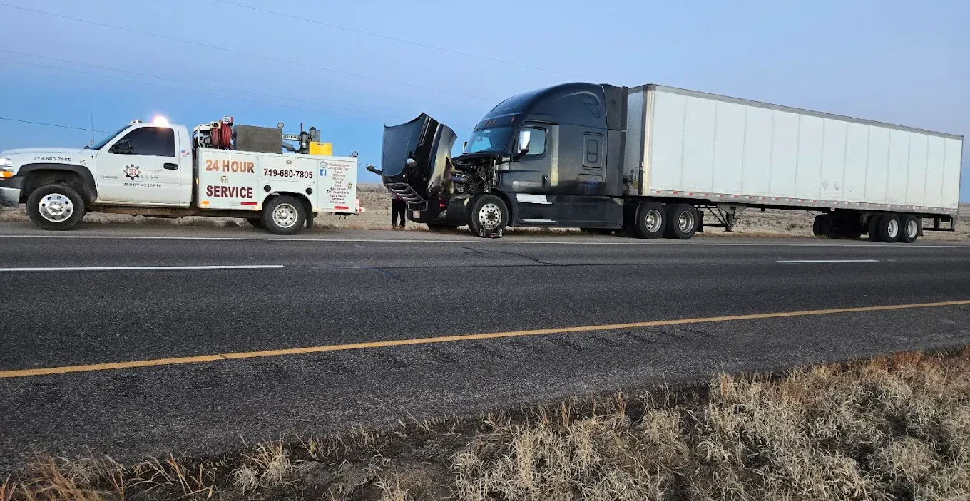 Accident involving a semi-truck and towing service vehicle on the highway.