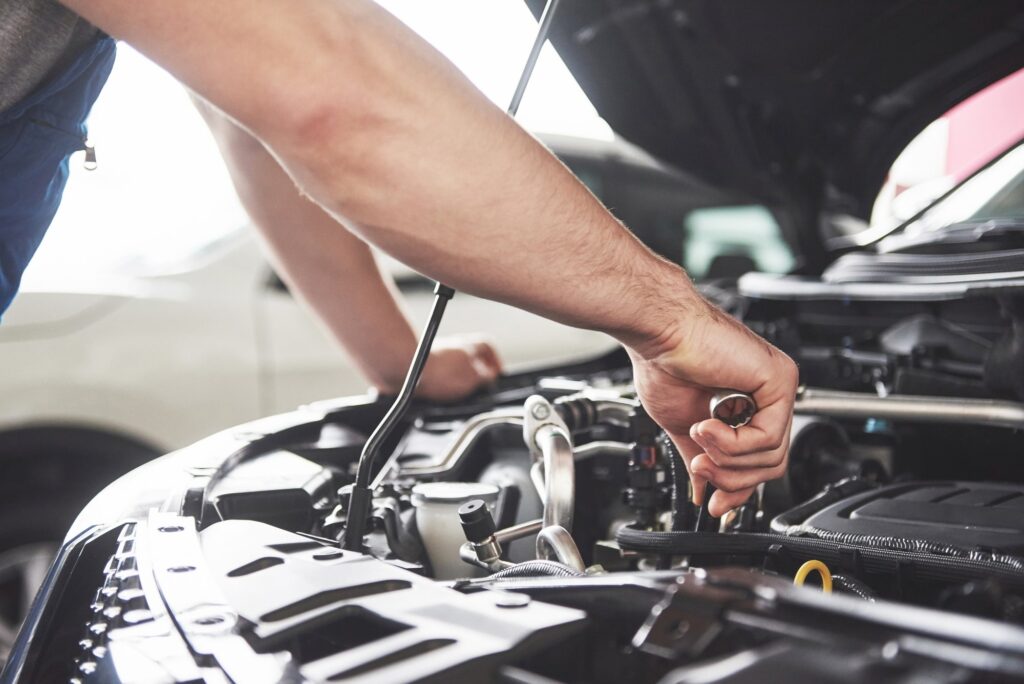 Technician inspecting a diesel engine for repair and maintenance.