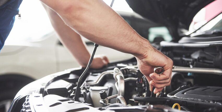 Technician inspecting a diesel engine for repair and maintenance.