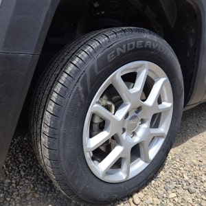 Tire and wheel service featuring a close-up of a vehicle's tire and alloy wheel at ER Auto, Diesel,.