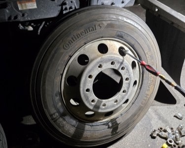 Close-up of a vehicle tire mounted on a rim at ER Auto, Diesel & Tire LLC.