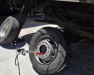 Vehicle tire being replaced with a new tire at ER Auto, Diesel, & Tire LLC.