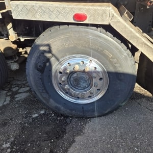 Heavy-duty truck tire with rim at ER Auto, Diesel, & Tire LLC.