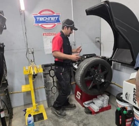 Auto technician inspecting a tire at ER Auto, Diesel, & Tire LLC.
