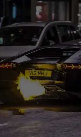 High-performance European sports car emitting a flame from exhaust pipe.
