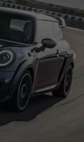 European automotive compact car driving on highway with scenic background.