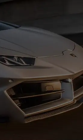 Close-up of a sleek silver luxury car front, highlighting modern design and LED headlights.