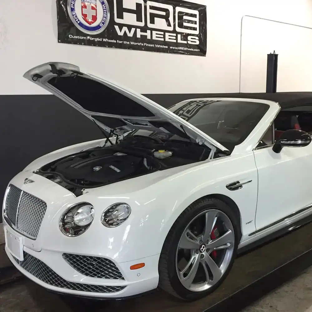 Luxury white convertible car with open hood at European Automotive.
