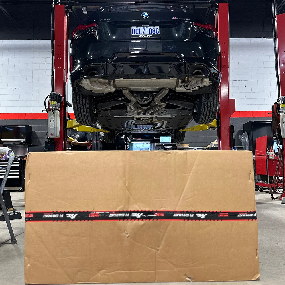 Black sports car lifted on hydraulic lift in European automotive workshop.
