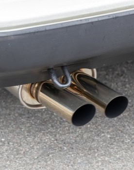Close-up of dual chrome exhaust pipes on a European car.