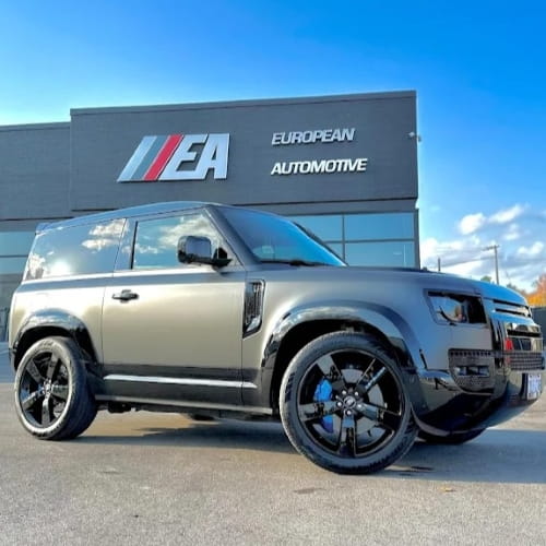 Luxury SUV parked outside European Automotive dealership in Canada.