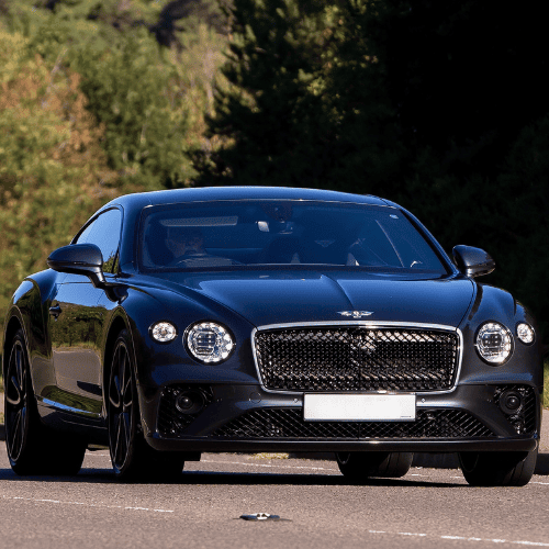 Black luxury sports car parked outdoors, showcasing sleek design.