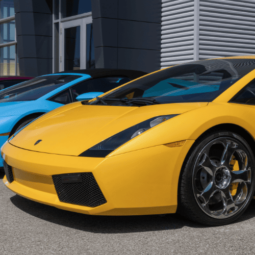 Luxury yellow sports car with sleek design parked outside automotive service center.