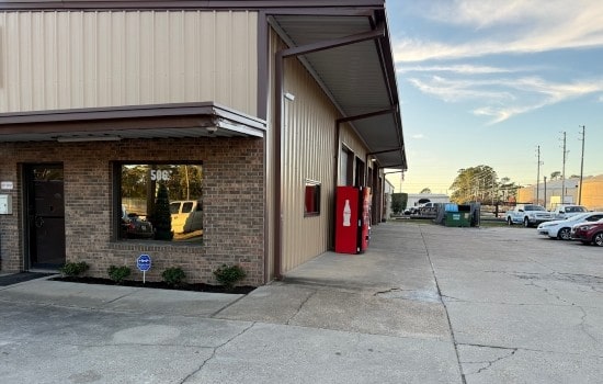 Auto repair shop exterior with service bays and parking.