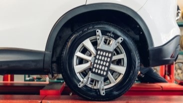 Car wheel on alignment machine at Express Tire and Auto Service.