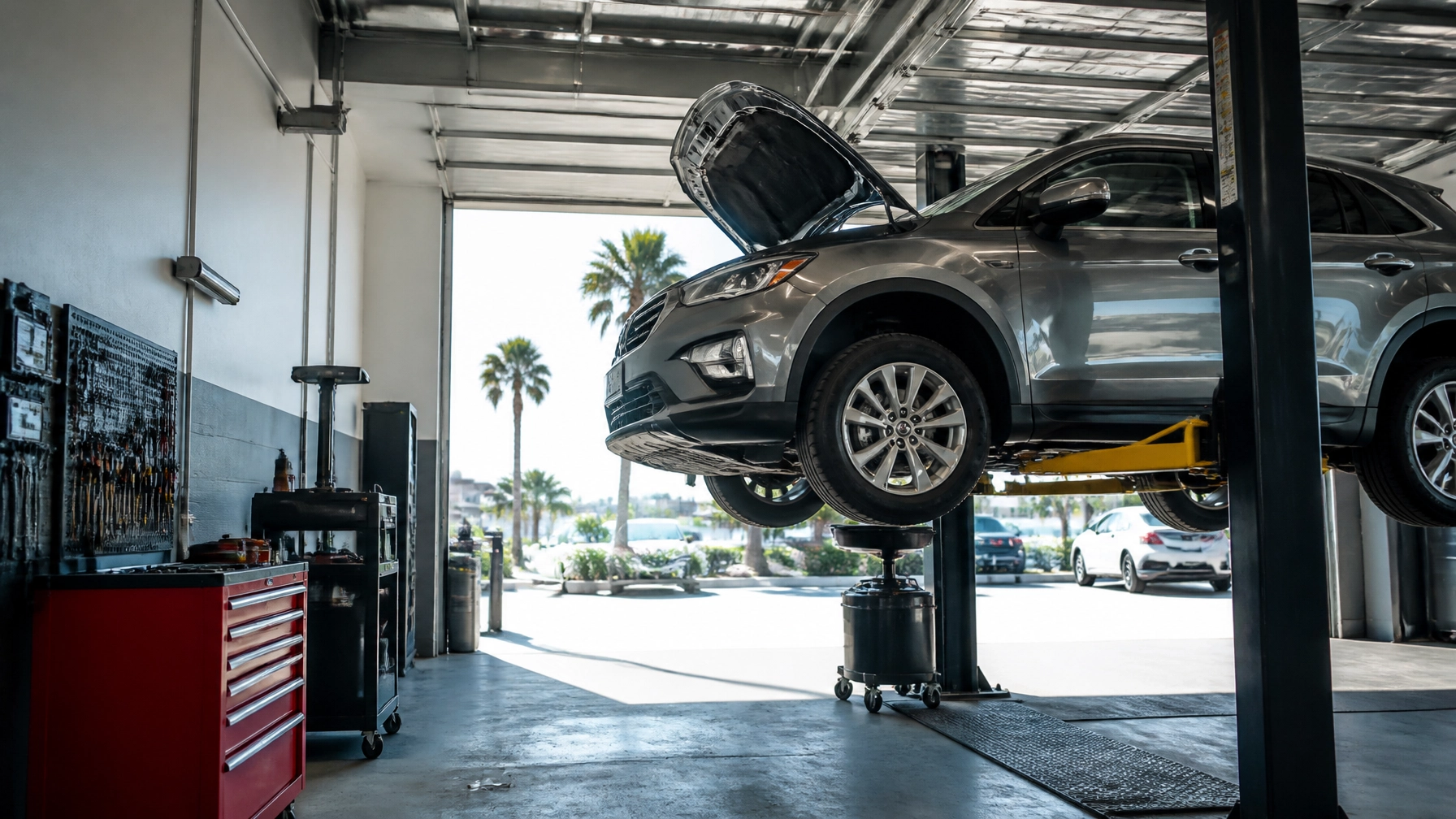 Car on lift at Express Tire And Auto Service for maintenance and repairs.