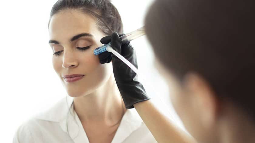 Esthetician giving PERK Eye Treatment
