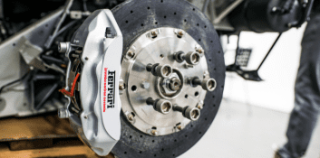 High-performance brake system with Ferrari caliper and drilled rotor.