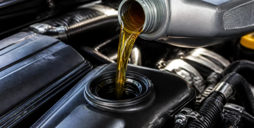 Vehicle oil being poured during an oil change at Fedora Tire & Oil LLC.