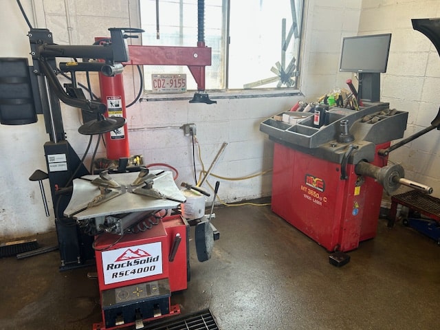 Auto repair shop tools and machinery for vehicle maintenance and diagnostics.