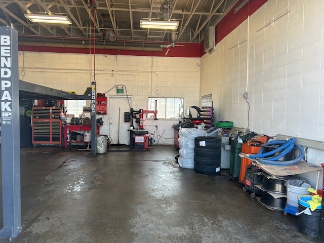 Auto repair shop with tools and equipment for vehicle maintenance.