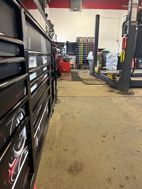 Auto repair shop with tools and equipment for vehicle maintenance.