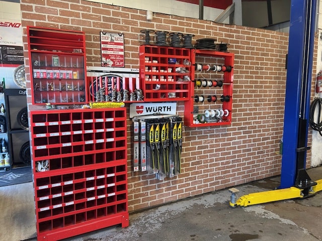 Organized auto parts storage with red shelving at First Auto Garage.
