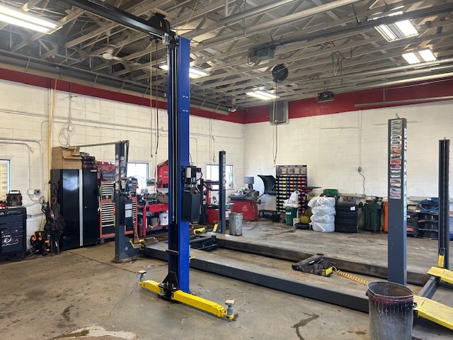 Auto repair shop with vehicle lifts, tools, and equipment for car maintenance and repairs.